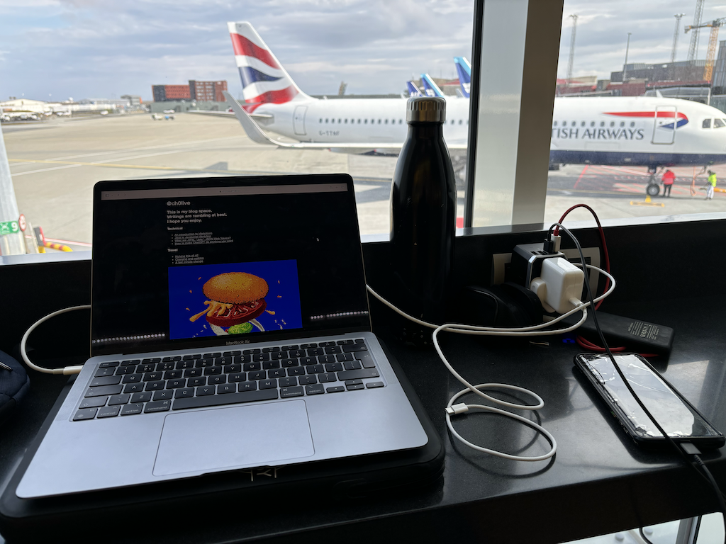 Laptop and chargers overlooking the airport