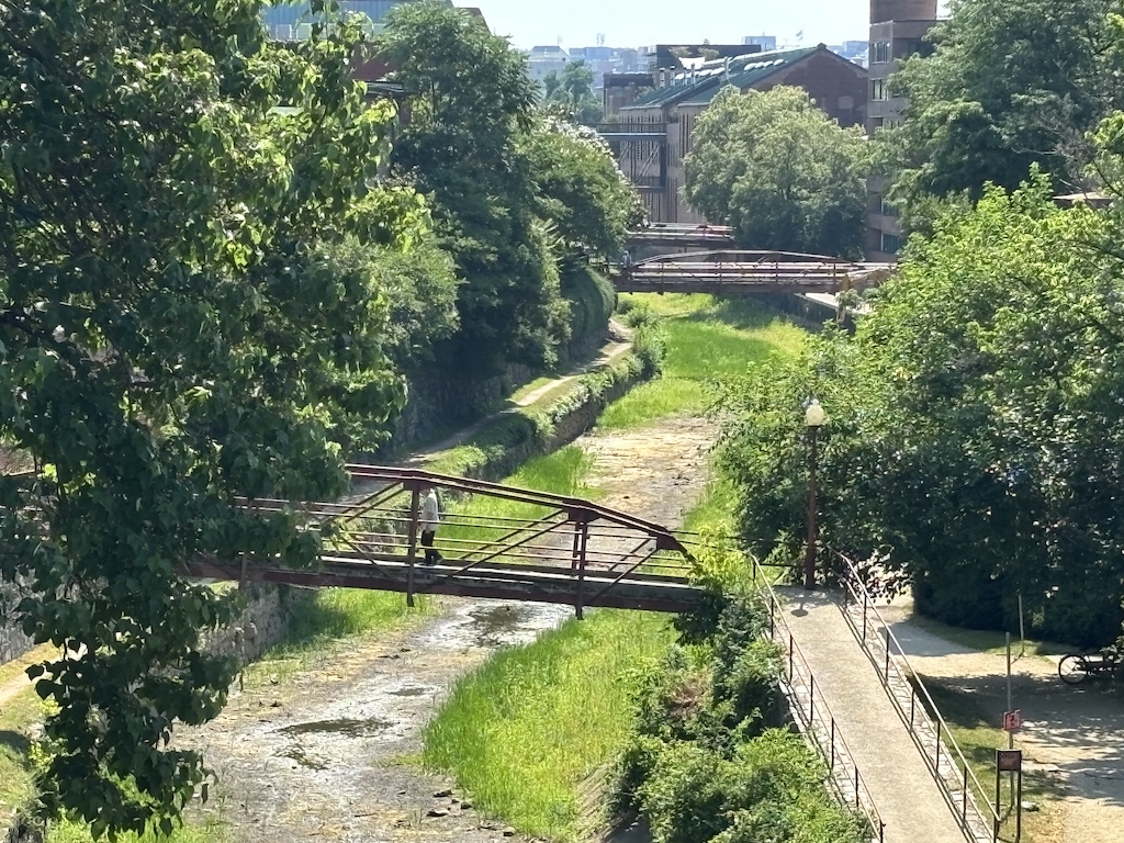 Rusted bridges cross a dried river bed